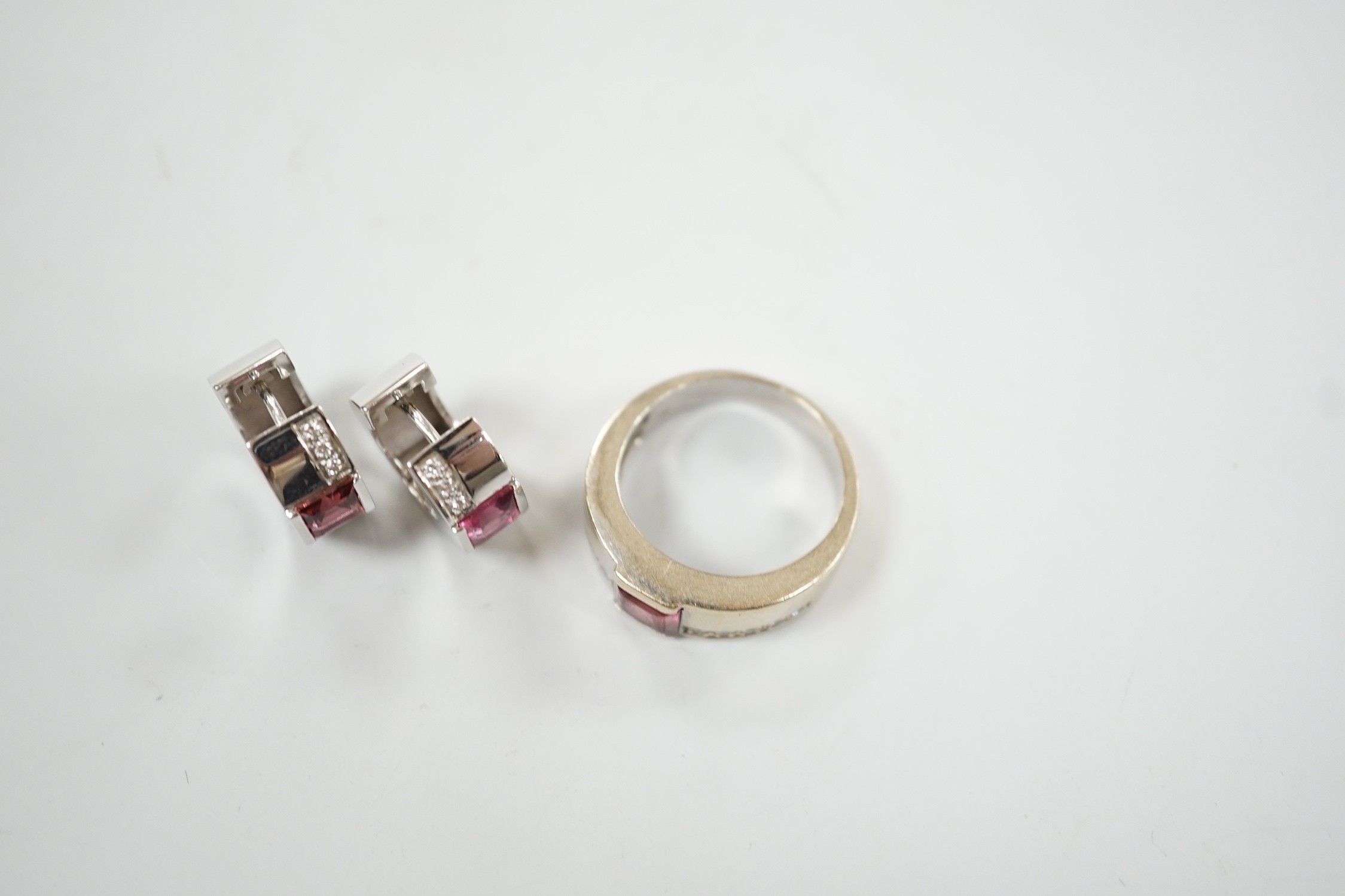 A modern 18ct white gold, pink tourmaline and diamond chip set suite of jewellery, comprising a ring, size O and pair of matching hoop earrings, 15mm, gross weight 16.8 grams.